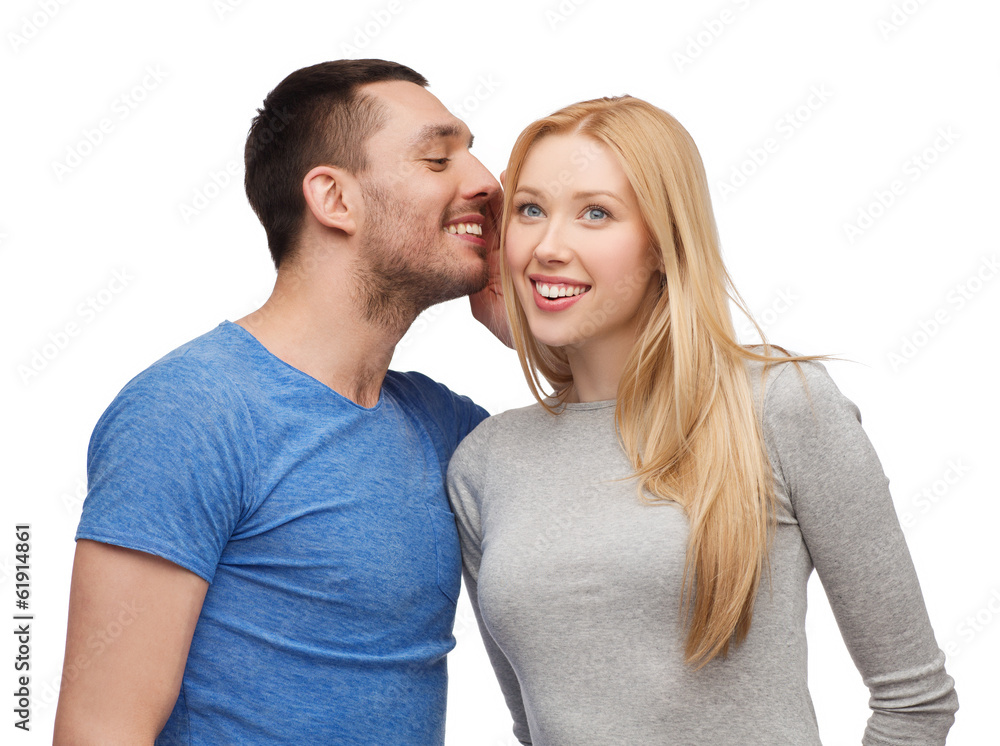 smiling boyfriend telling girlfriend secret smiling boyfriend telling girlfriend secret