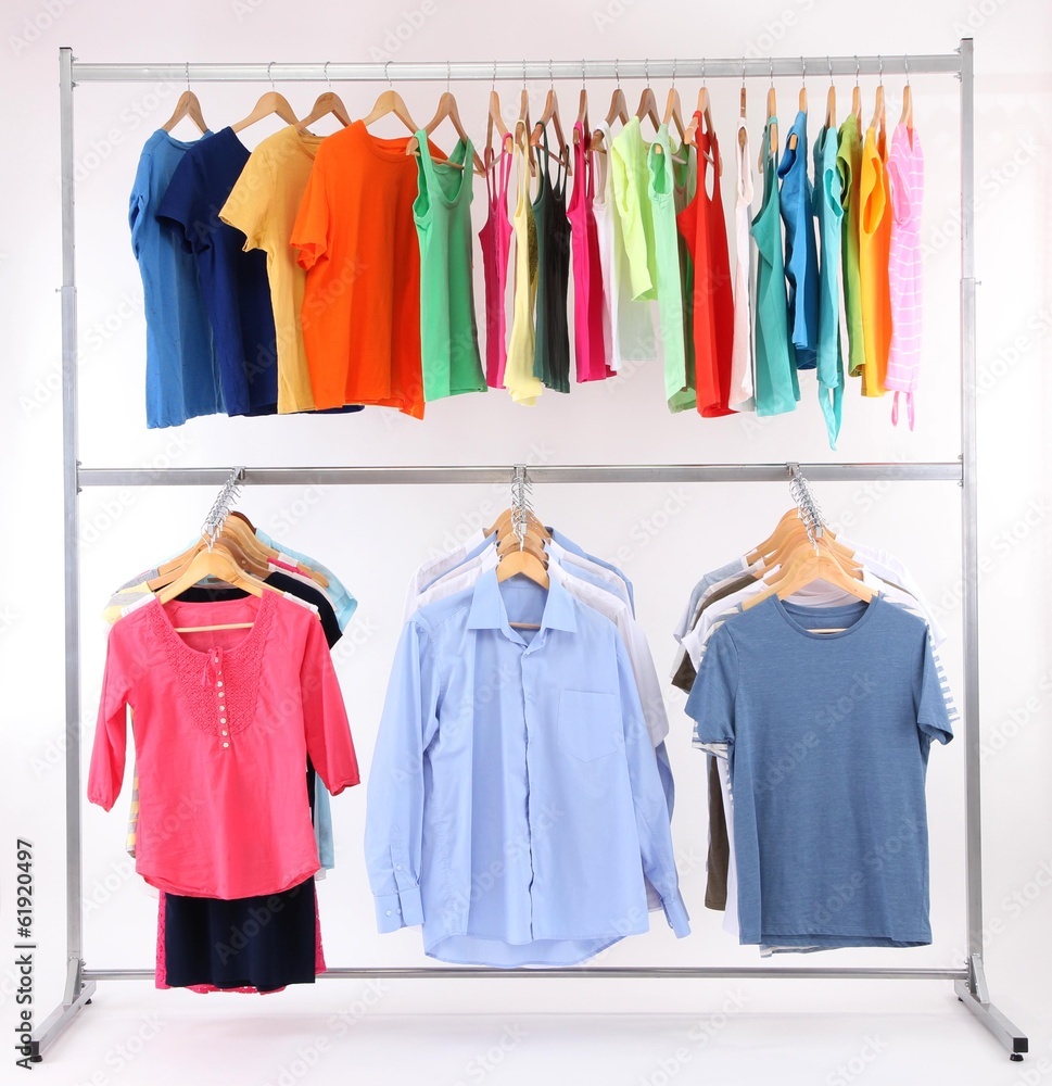 Different clothes on hangers, on gray background Different clothes on hangers, on gray background
