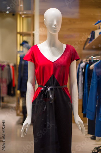 Woman mannequin with red-black dress in store
