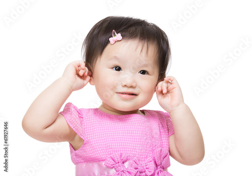Adorable little girl plugs her ears