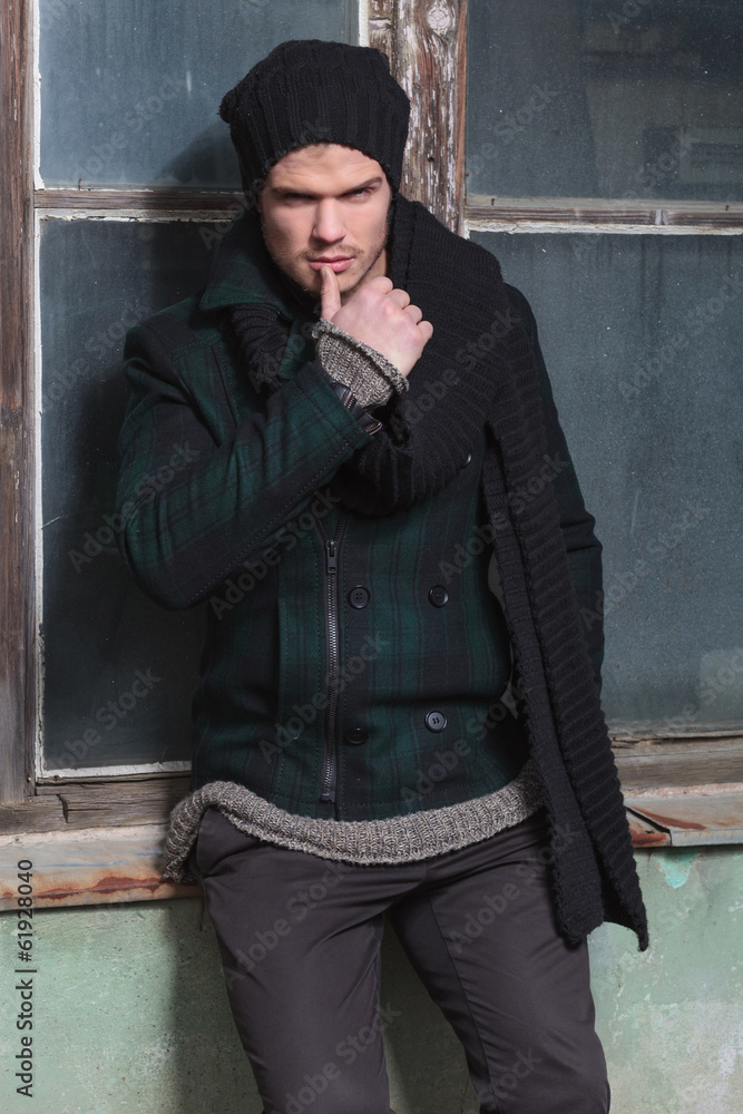 Obraz premium young fashion man touches his lip