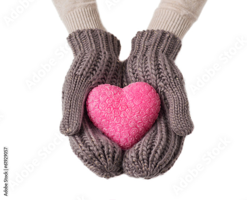 Pink heart in warm wool gloves