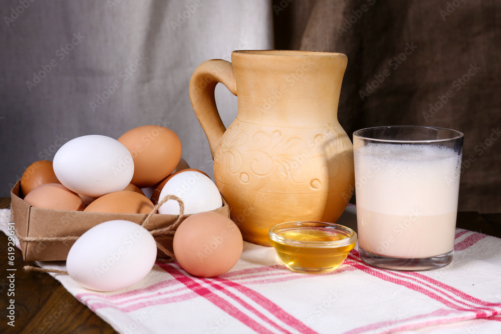 Eggnog with milk and eggs on table and fabric background Eggnog with milk and eggs on table and fabric background