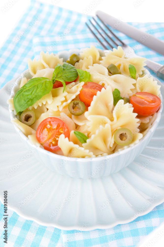 Delicious pasta with tomatoes on plate on table close-up Delicious pasta with tomatoes on plate on table close-up