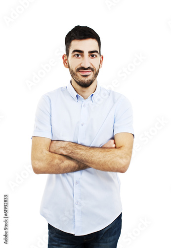 Casual young man with arms crossed and satisfaction