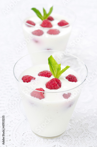 panna cotta with fresh raspberries, vertical close-up