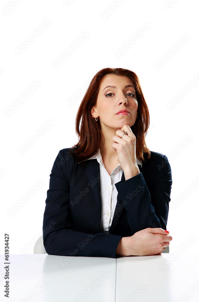 Pensive businesswoman sitting on the table Pensive businesswoman sitting on the table