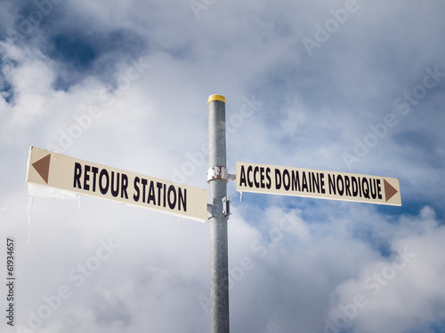 ski area sign post with sky behind photo