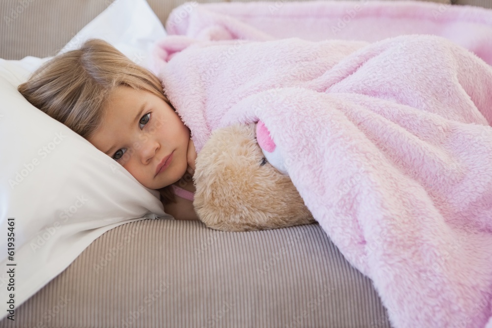 Young girl resting on sofa with stuffed toy Young girl resting on sofa with stuffed toy