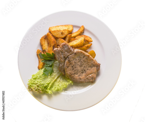 pork chops with potatoes on a white plate