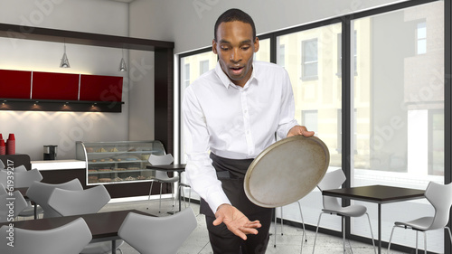 young male waiter dropping a tray and falling forward photo