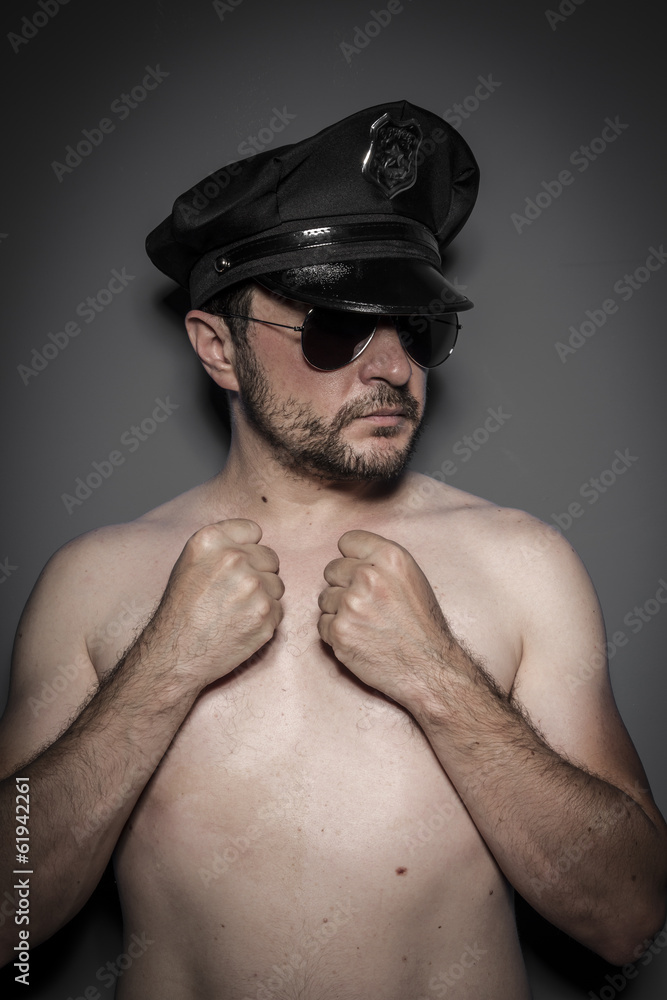 Good looking policeman, sexy police with sunglasses over dark ba Good looking policeman, sexy police with sunglasses over dark ba
