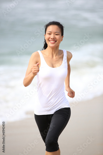 fitness woman running at beach