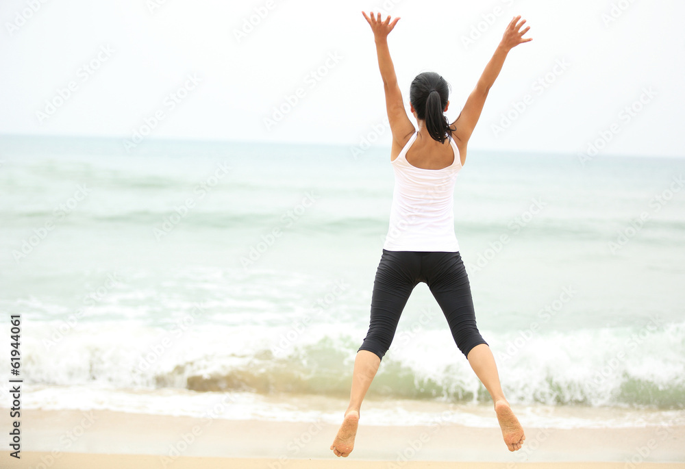 happy woman jumping at seaside beach in summer holidays happy woman jumping at seaside beach in summer holidays