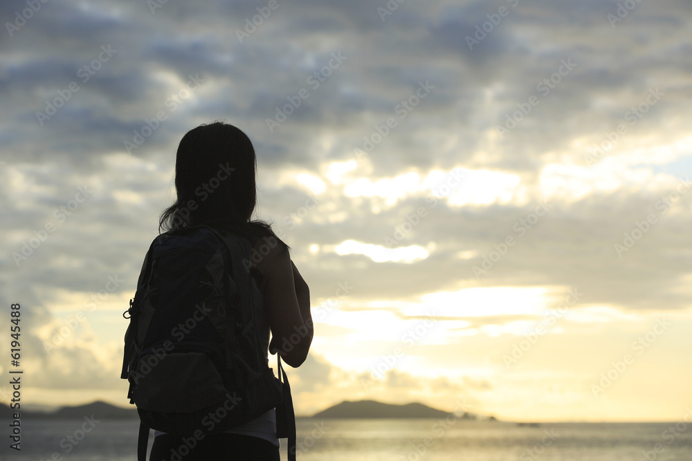 woman hiker enjoy the view at sunrise seaside 