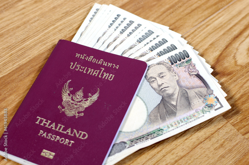 Fototapeta premium Japanese banknotes and Thailand passport