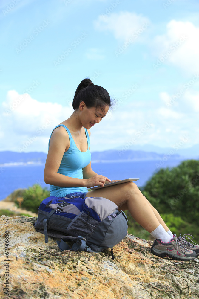 woman hiker  use digital tablet seaside