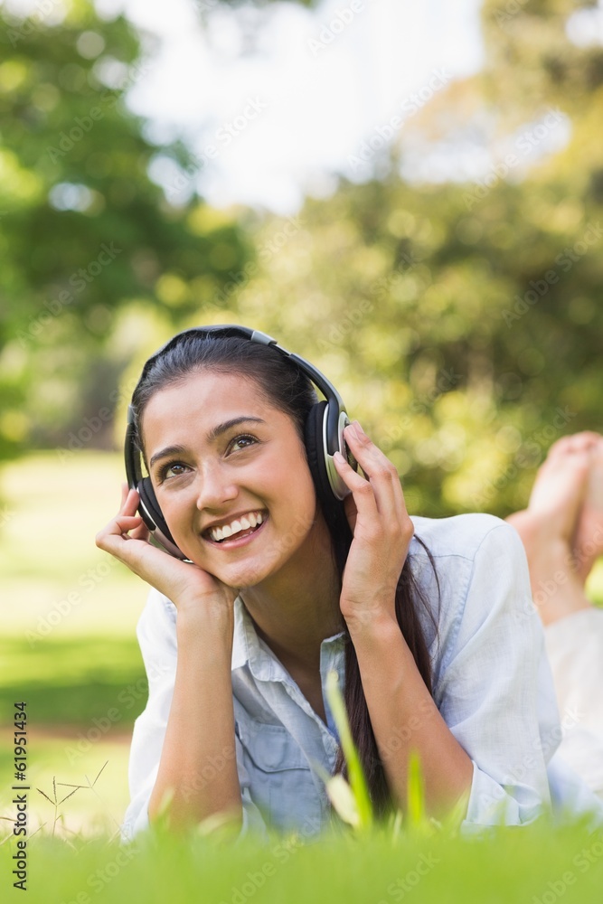 Cheerful young woman enjoying music in park Cheerful young woman enjoying music in park