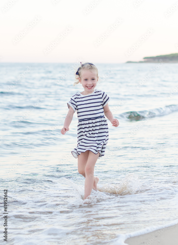 Little girl having fun on beach vacation. Place for text. Little girl having fun on beach vacation. Place for text.