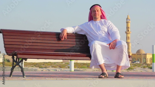 Muslim man rests, contemplates photo