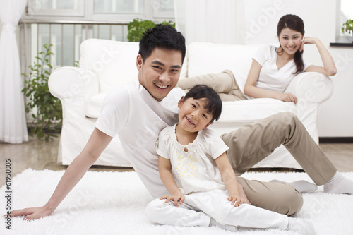 .Young family sitting in couch.