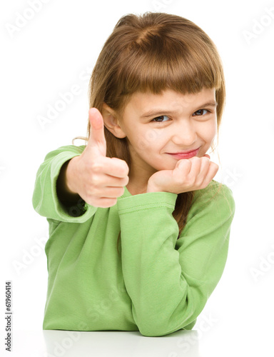 Little girl is showing thumb up sign