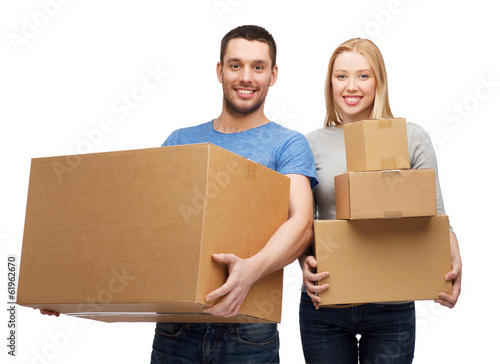 smiling couple holding cardboard boxes photo