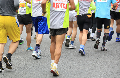 marathon athletes running on street 