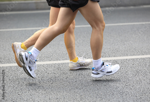 marathon athlete running on street 