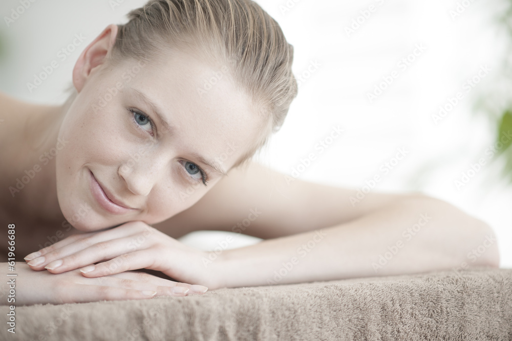 closeup of a beautiful young woman lying on a massage table closeup of a beautiful young woman lying on a massage table
