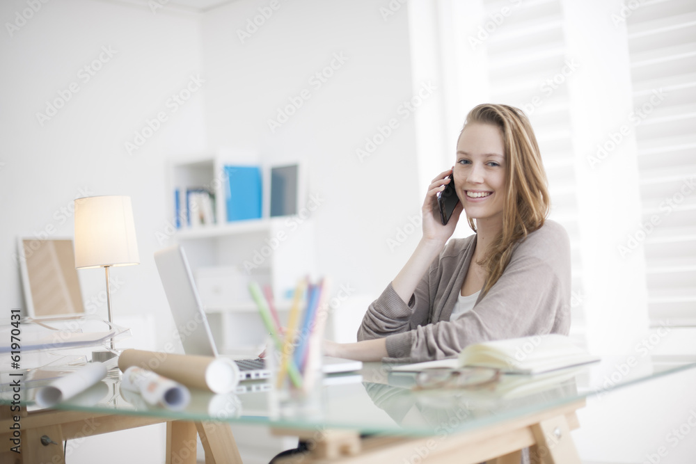 beautiful young woman on the workplace using his phone beautiful young woman on the workplace using his phone