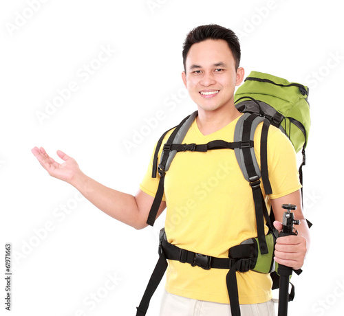 male hiker with backpack presenting