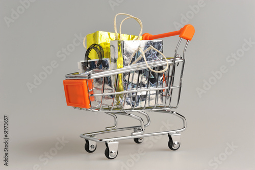 Shopping cart with packages on gray