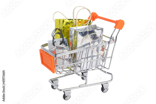 Shopping cart with packages isolated on white