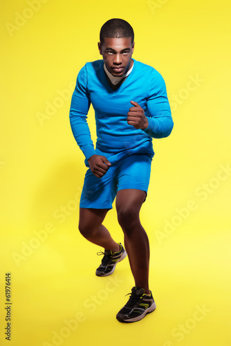 Athletic black man in sportswear fashion. Runner. Intense colors © ysbrandcosijn