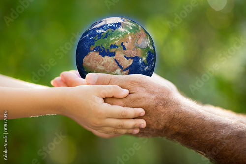 Child and man holding Earth in hands