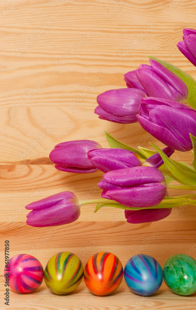 	Colorful easter eggs and purple tulip. 