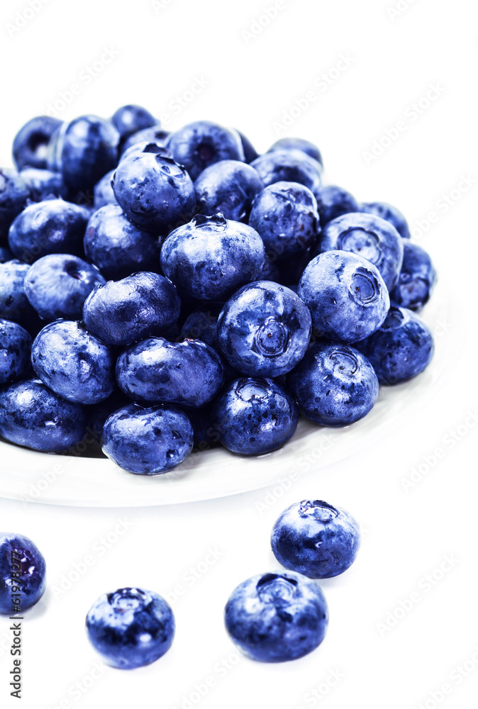Fresh Blueberries on white plate isolated on white background cl Fresh Blueberries on white plate isolated on white background cl