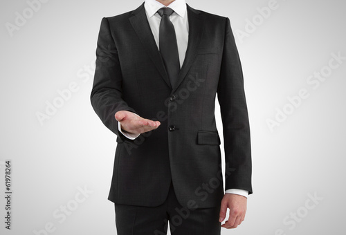 man in suit showing something