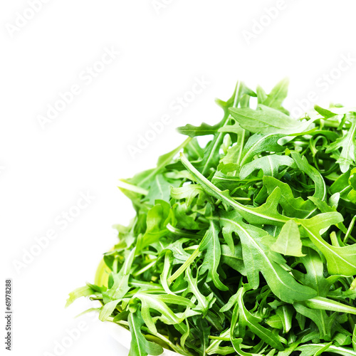 Arugula salad isolated on white background close up. Heap of fr