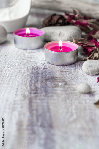Stones candles petals rose wooden background