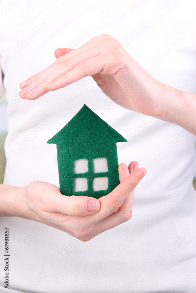 Little paper house in hand close-up Little paper house in hand close-up