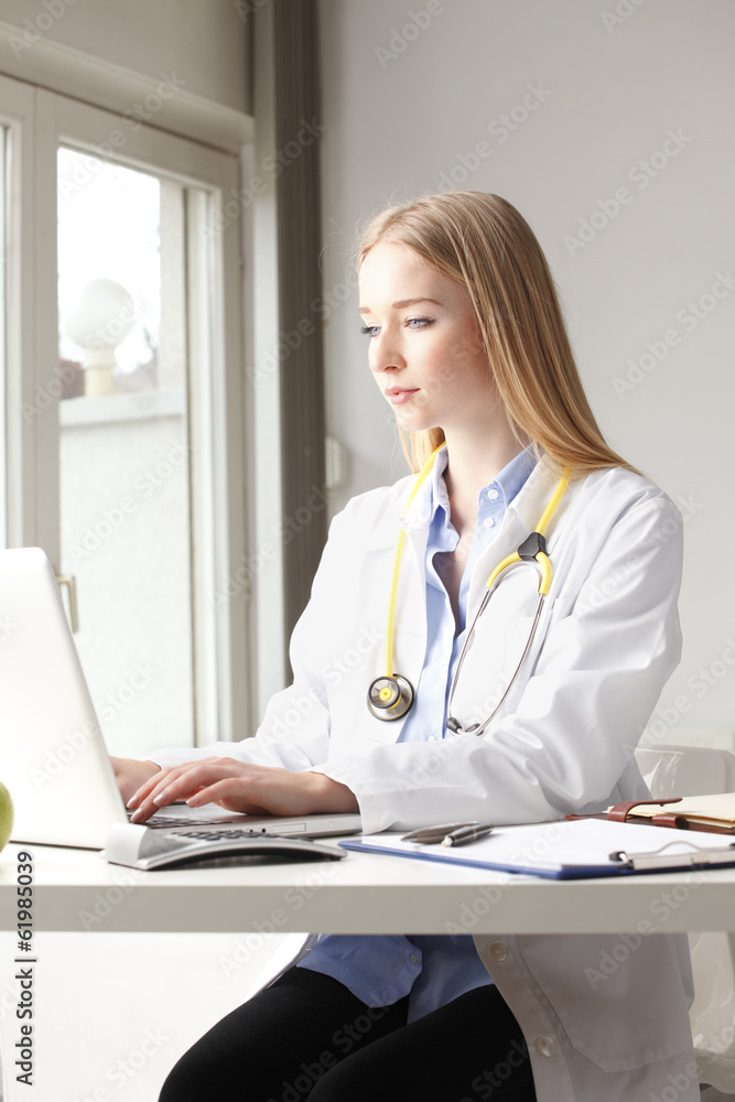 Close-up of a female doctor smiling and working Close-up of a female doctor smiling and working