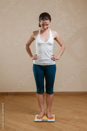 Caucasian woman posing at scales