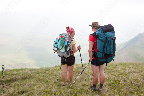 Hiker looks for the way in Carpathian mountains standing far abo