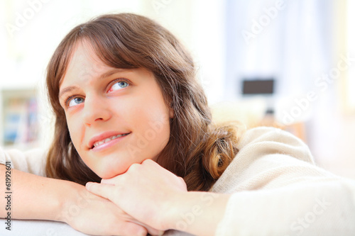 Portrait of a young attractive woman relaxing on sofa