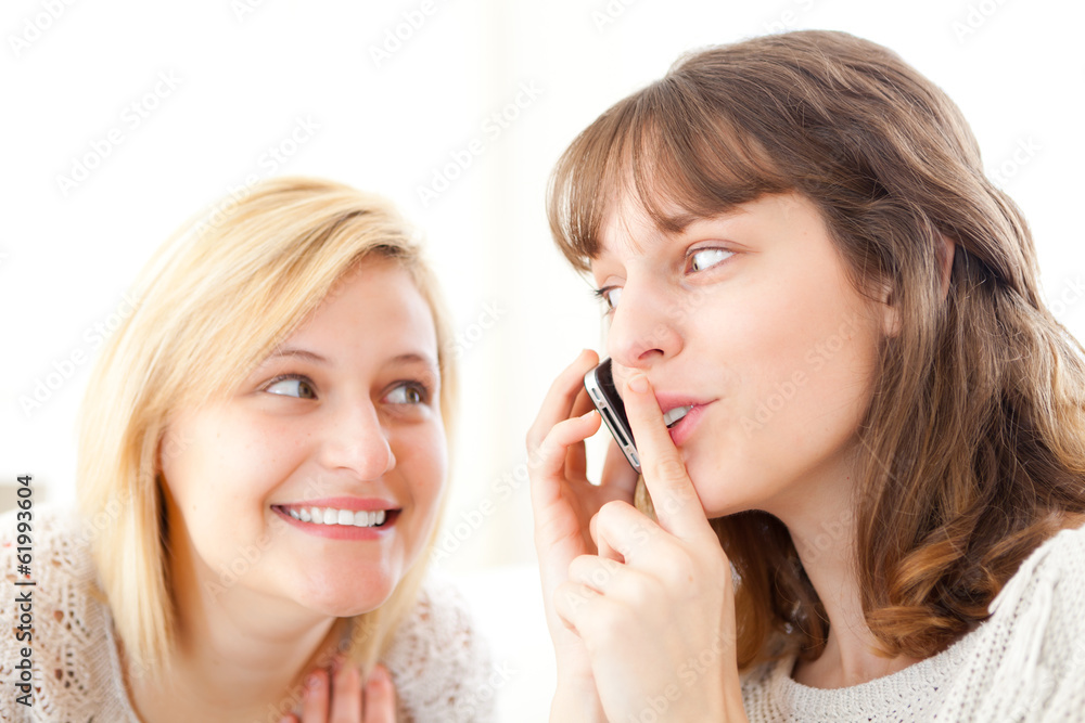 Blonde Girl trying to hear a conversation in a smartphone Blonde Girl trying to hear a conversation in a smartphone