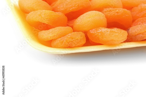 delicious dried apricots in packaging isolated on white