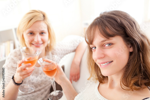 Girls having a toast in a sofa