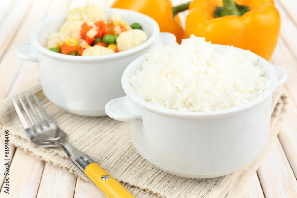 Cooked rice with vegetables on wooden table close up